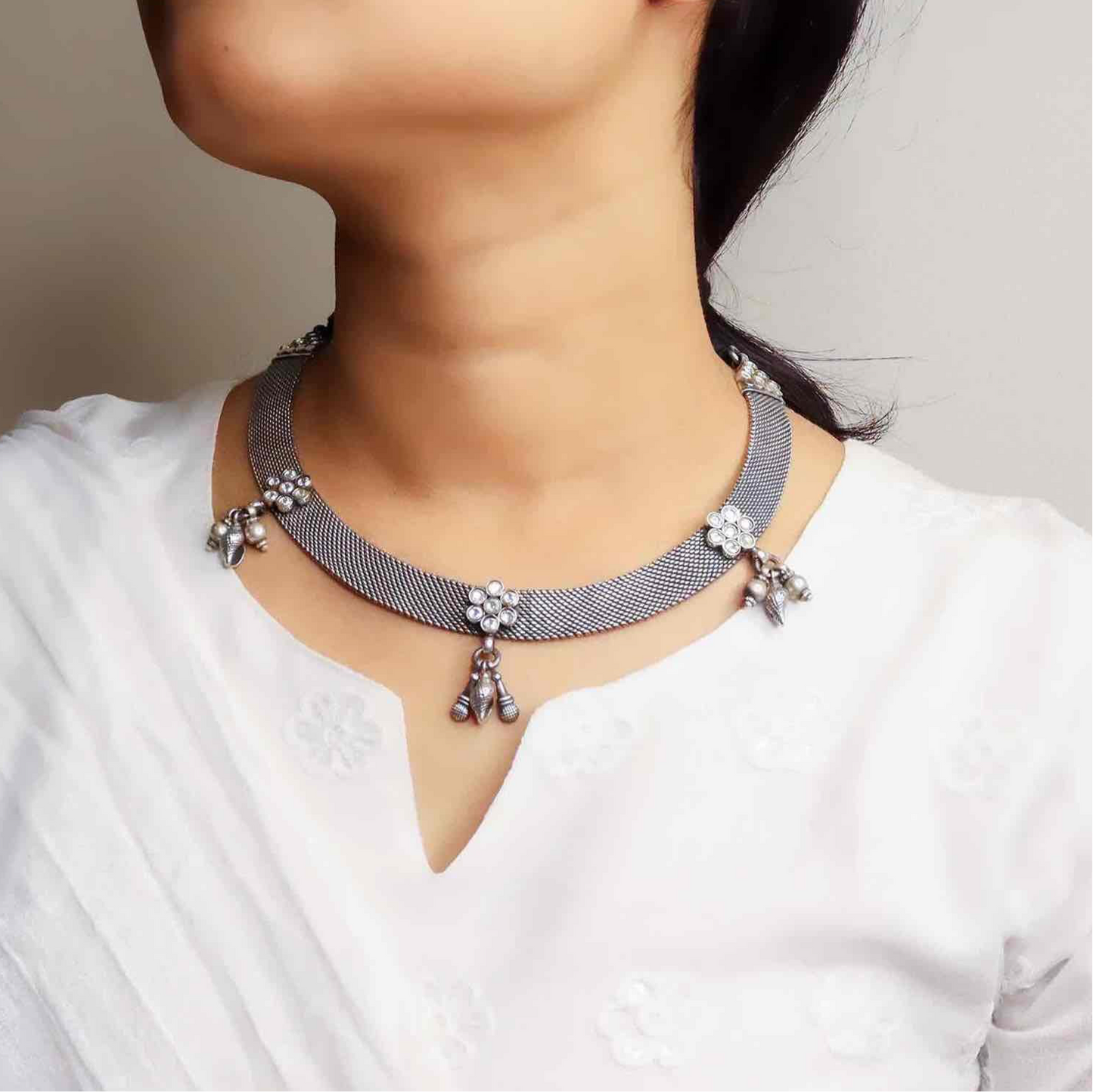 Beautiful oxidized silver necklace with intricate patterns and a vintage finish, offering a bold, antique look for statement styling.