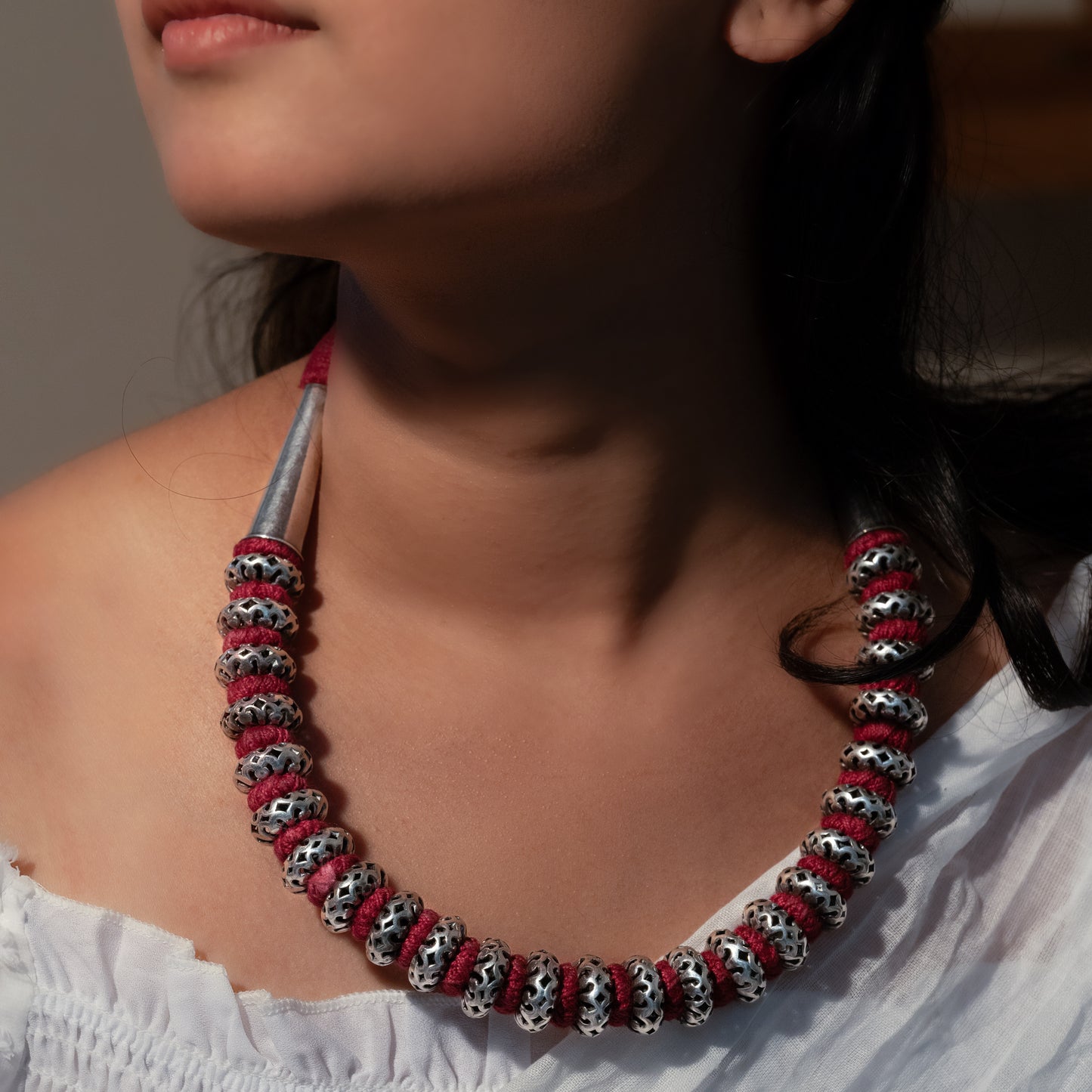 Handcrafted sterling silver long necklace featuring intricate detailing and a polished finish."