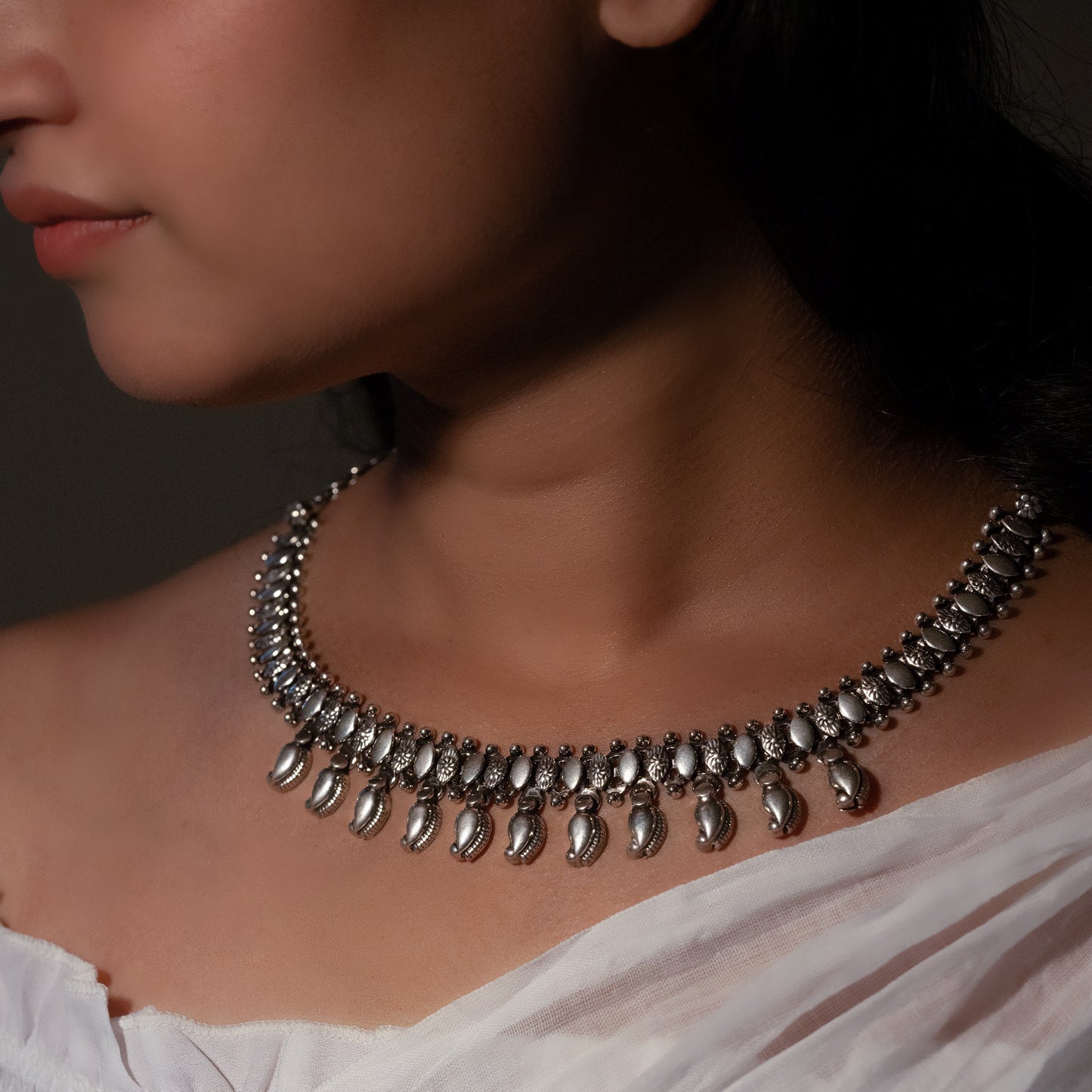 Oxidized silver choker with antique finish, showcasing a detailed motif for a vintage aesthetic."
