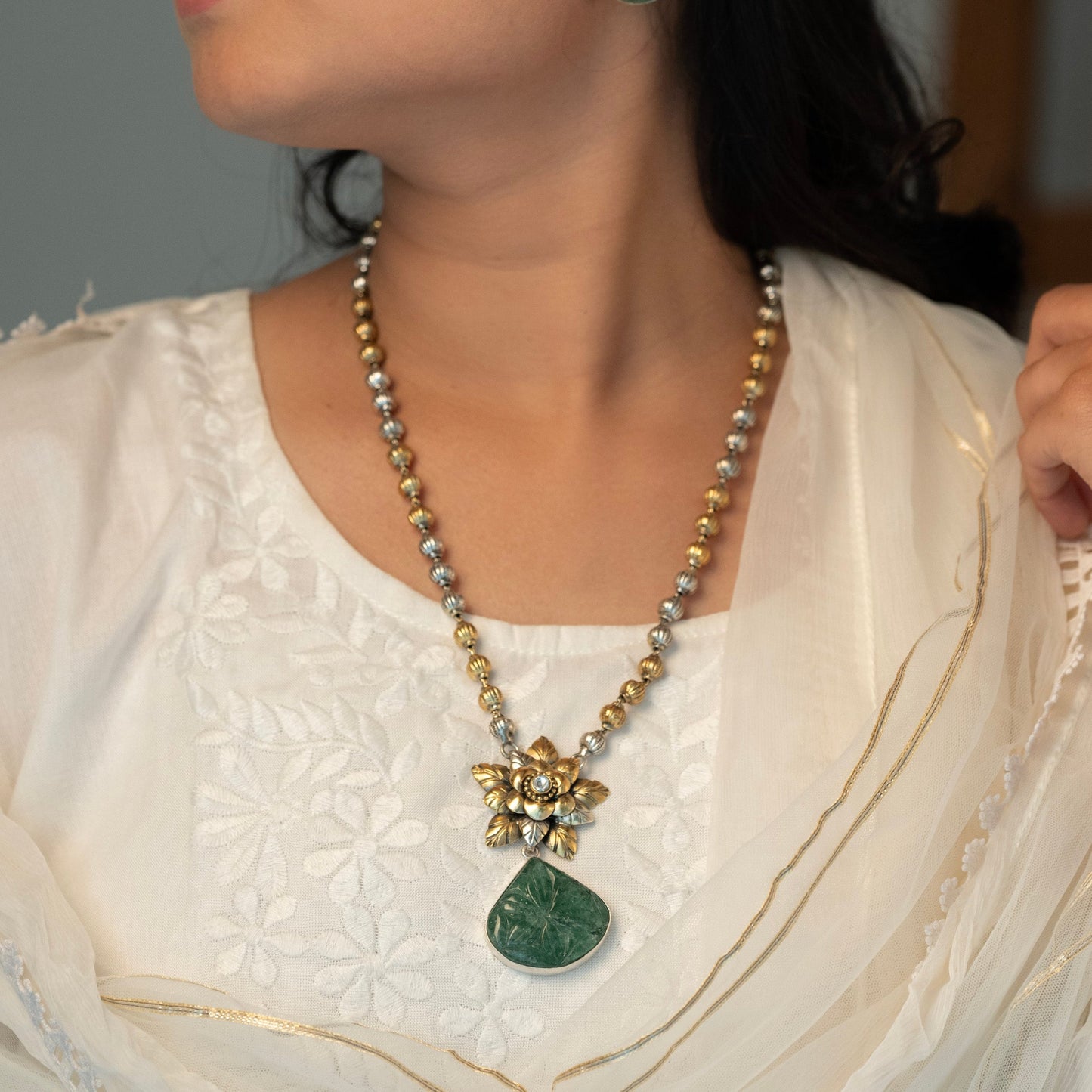 Long sterling silver necklace with a big green colour stone at centre, adding a touch of sophistication to any outfit