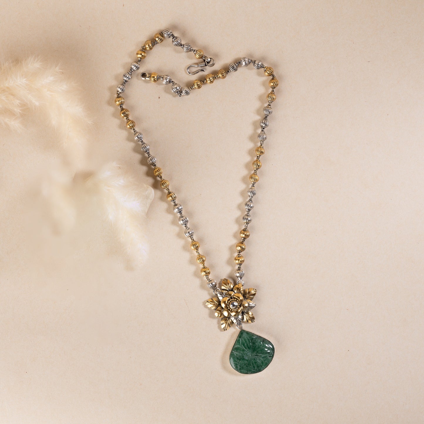 Long sterling silver necklace with a big green colour stone at centre, adding a touch of sophistication to any outfit