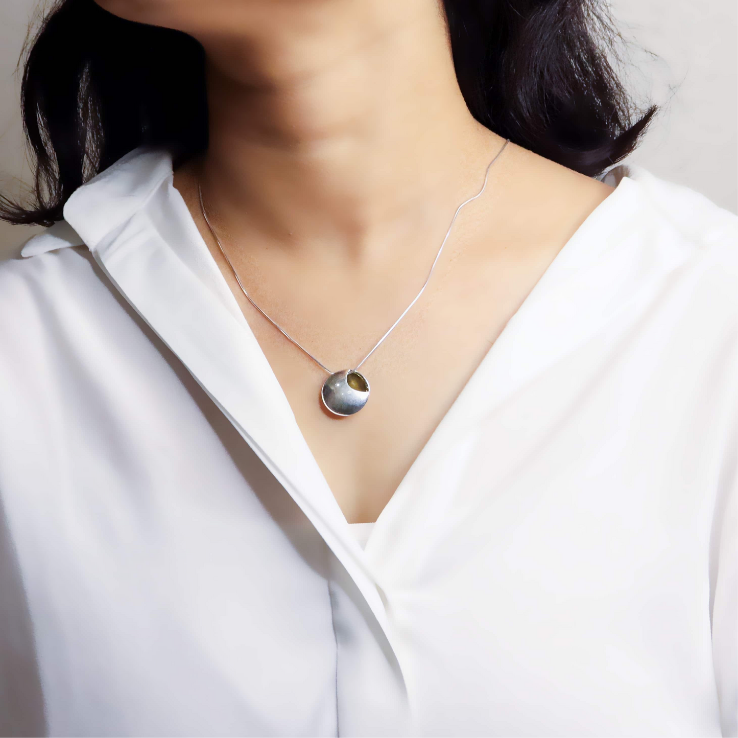 image of a delicate silver chain, showcasing its fine links and shiny, polished finish.
