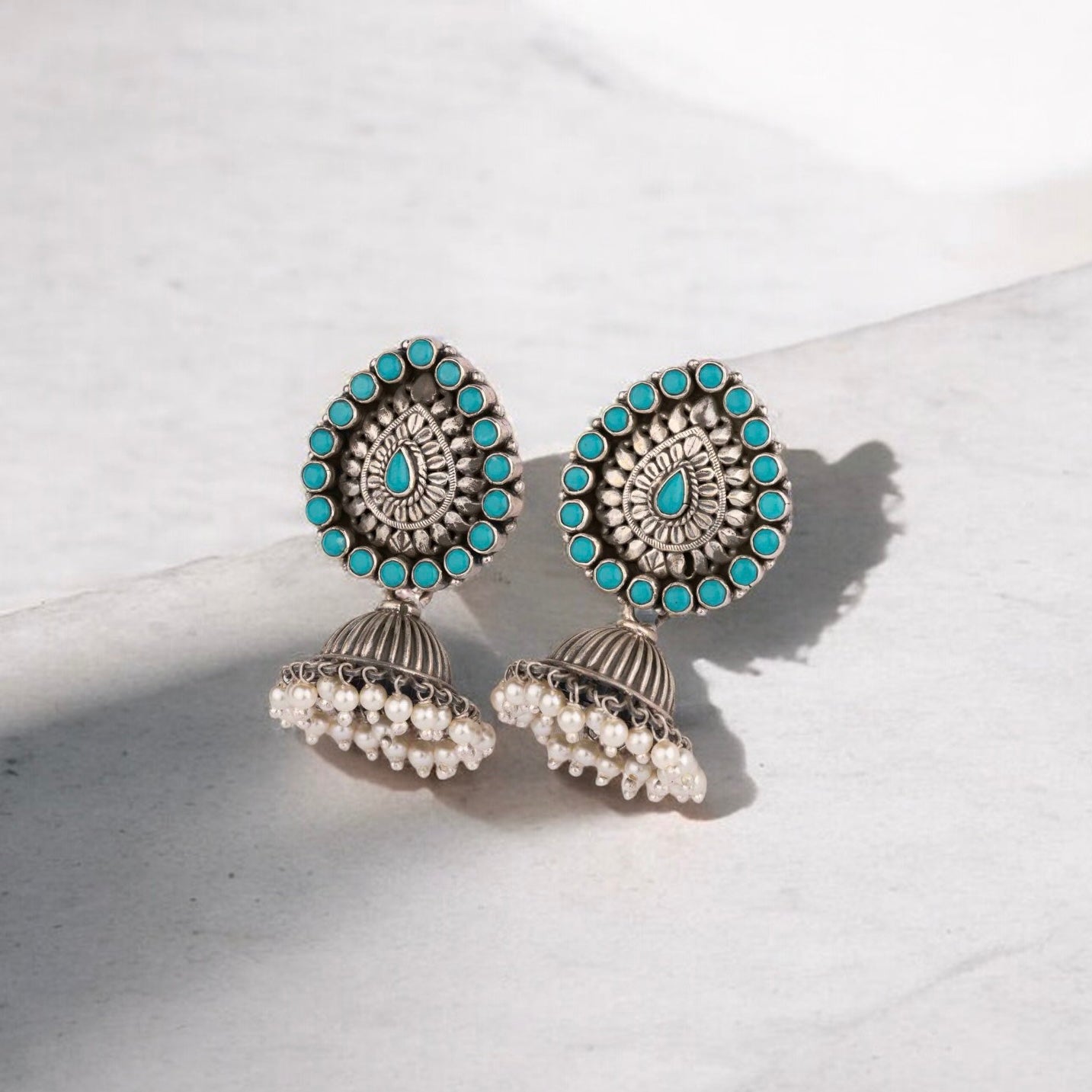 Intricately designed silver oxidized jhumka earrings with a traditional and vintage-inspired charm.