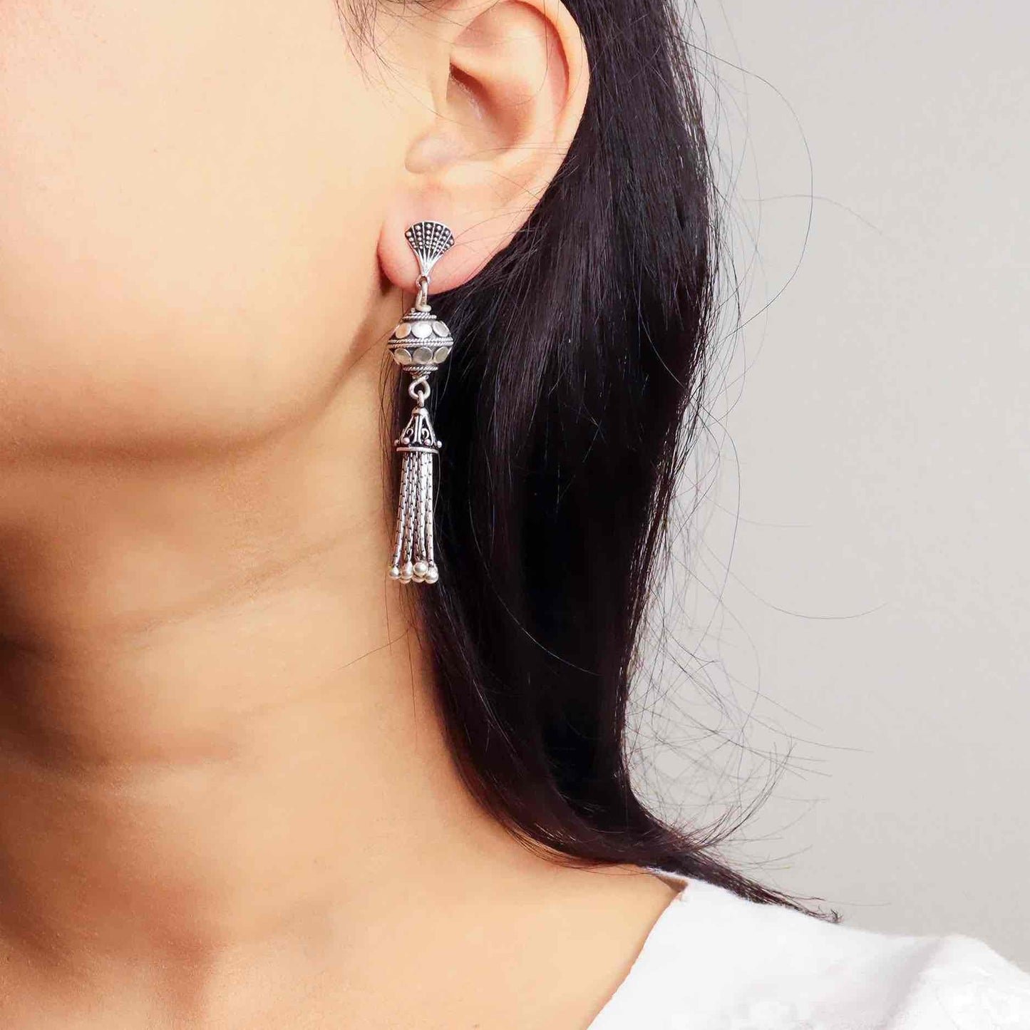 Elegant silver oxidized long earrings with intricate patterns and vintage-inspired charm