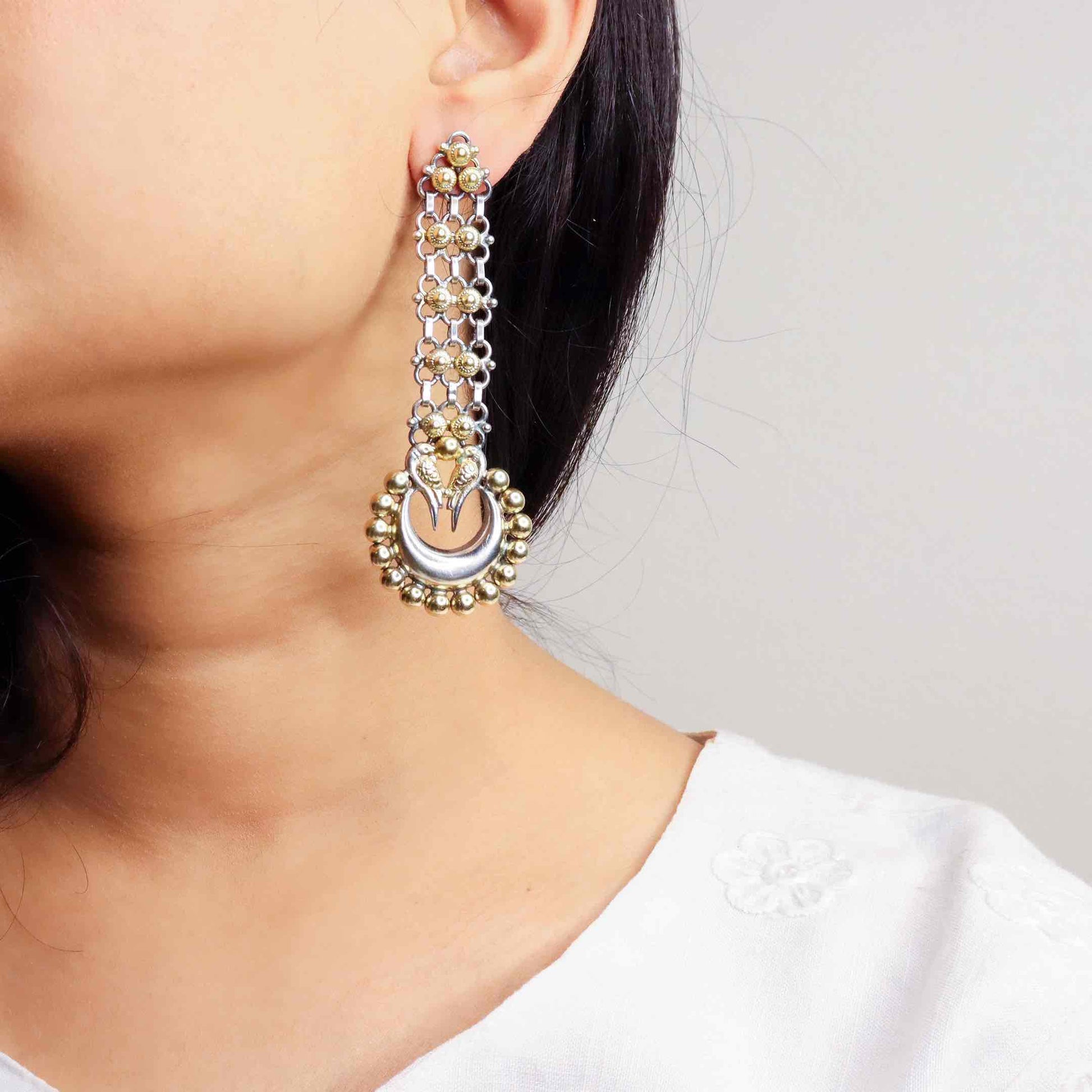 Stunning silver chandbali earrings with intricate detailing, embodying traditional elegance and grace. 