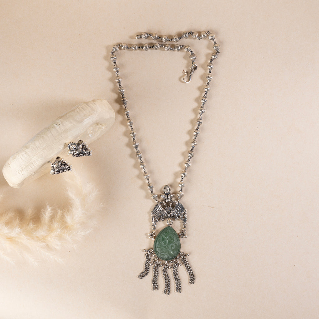Long sterling silver necklace with a big green colour stone at centre, adding a touch of sophistication to any outfit