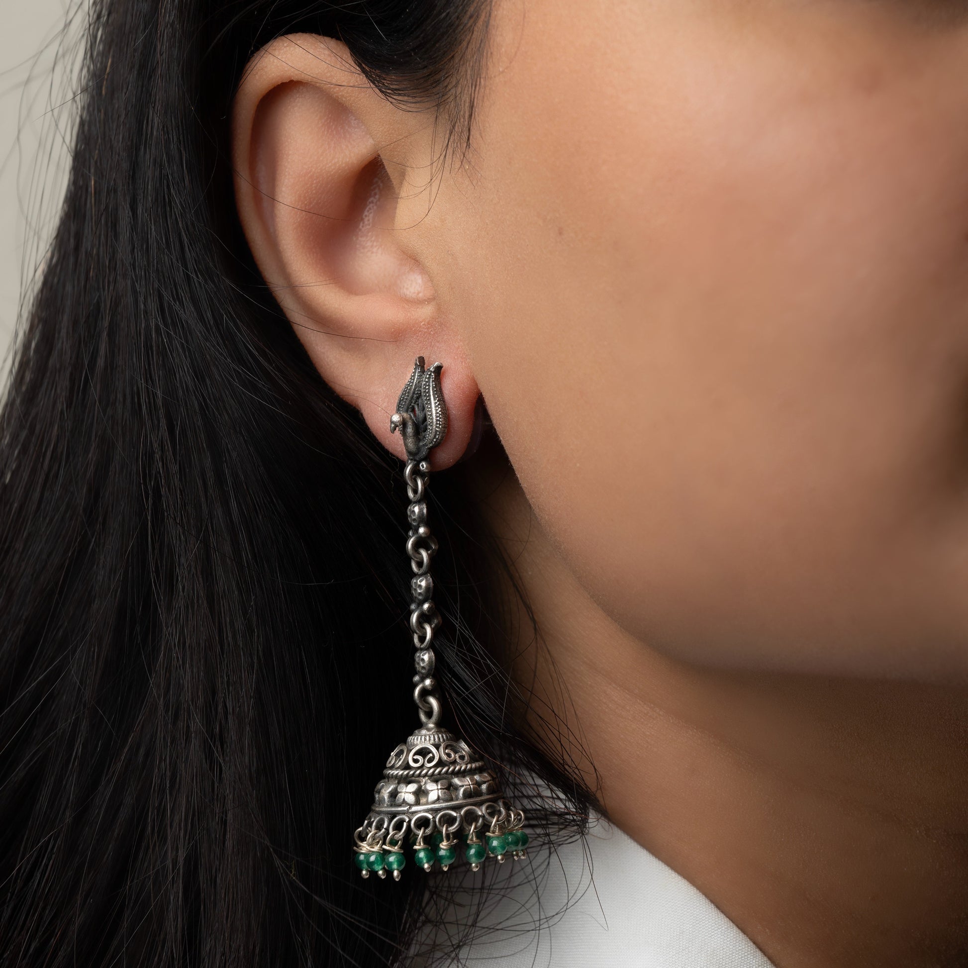 Intricately designed silver oxidized jhumka earrings with a traditional and vintage-inspired charm.