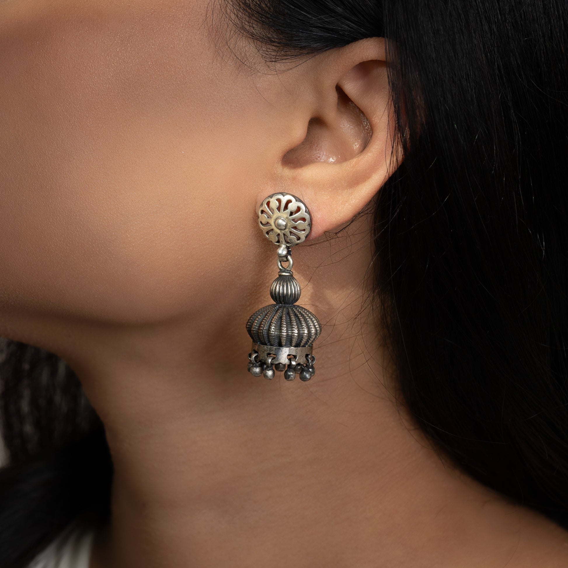 Intricately designed silver oxidized jhumka earrings with a traditional and vintage-inspired charm.