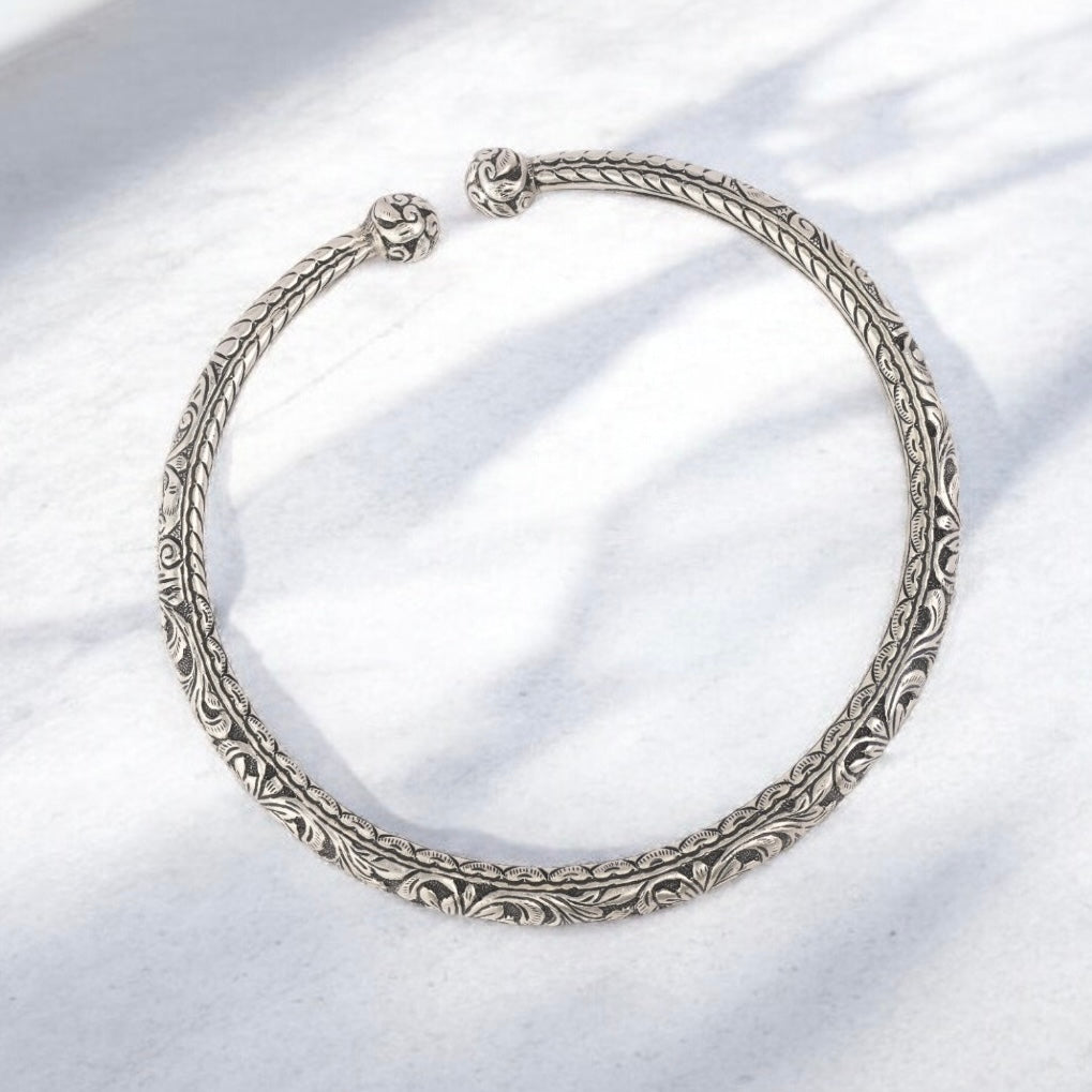 Beautiful oxidized silver choker with intricate patterns and a vintage finish, offering a bold, antique look for statement styling.
