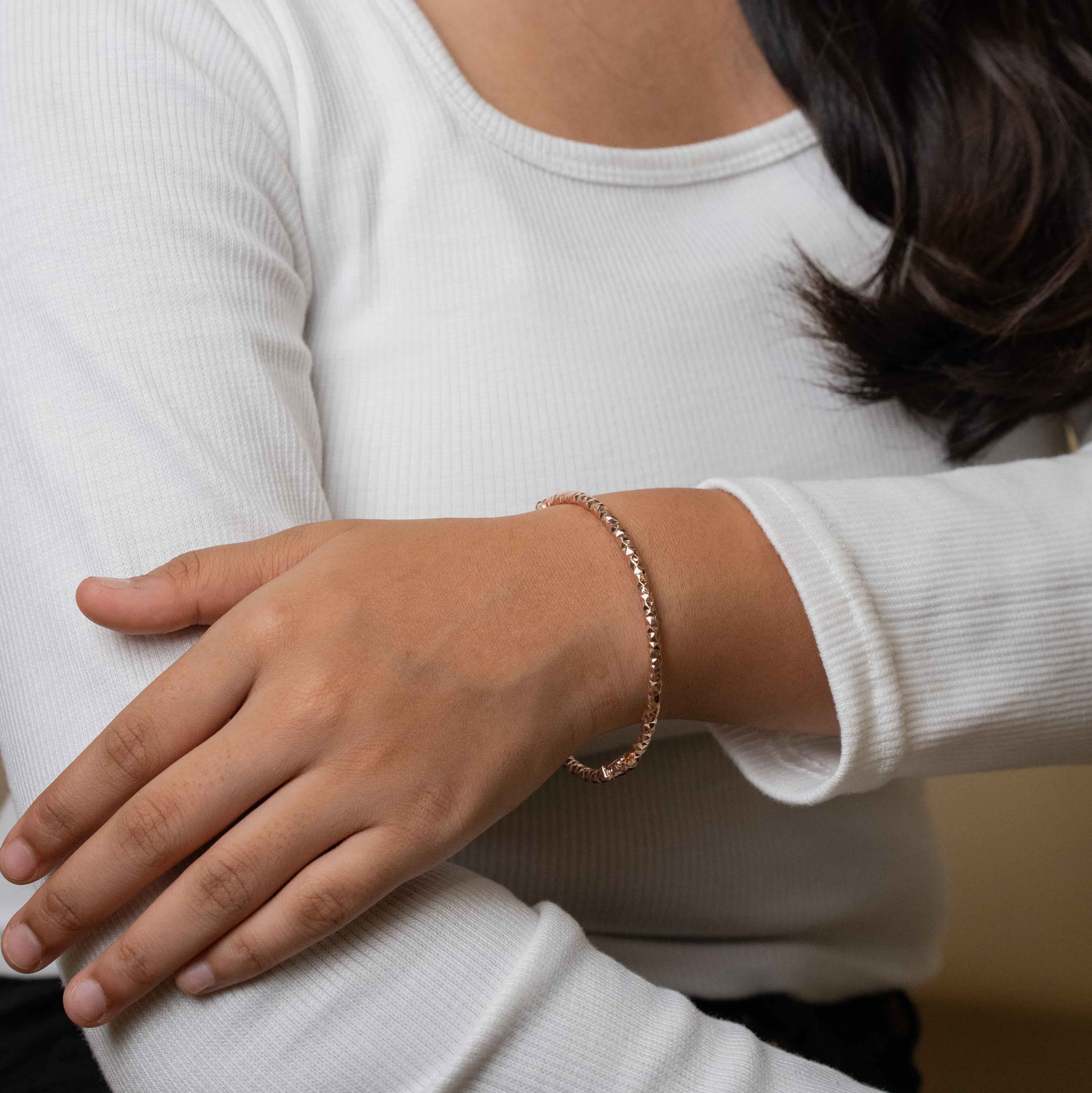 Elegant silver bracelet with a rose gold finish for women, featuring a sleek and sophisticated design, perfect for adding a touch of warmth and luxury to any outfit.

