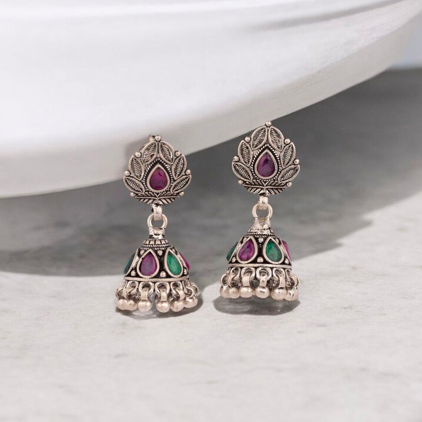 Intricately designed silver oxidized jhumka earrings with a traditional and vintage-inspired charm.