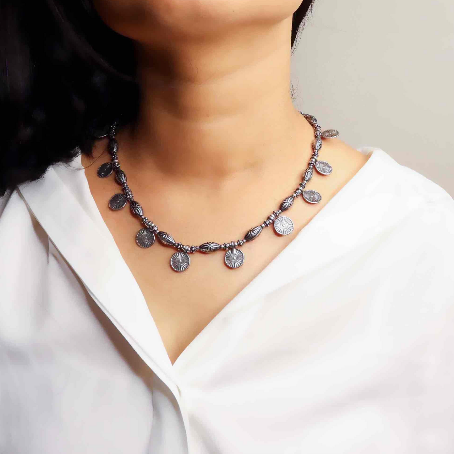 Beautiful oxidized silver necklace with intricate patterns and a vintage finish, offering a bold, antique look for statement styling.
