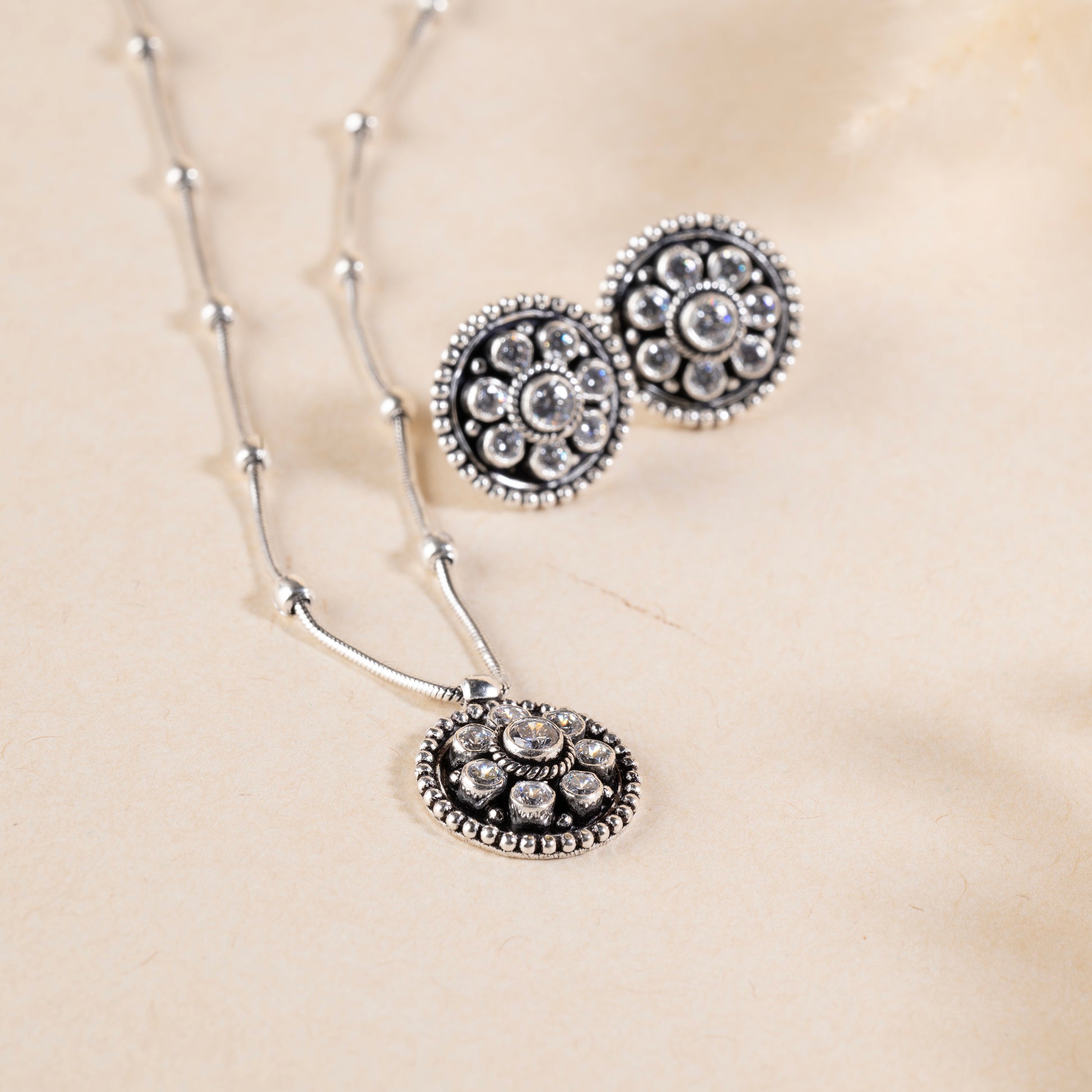 Delicate silver pendant necklace with a sparkling gemstone, set on a fine silver chain."