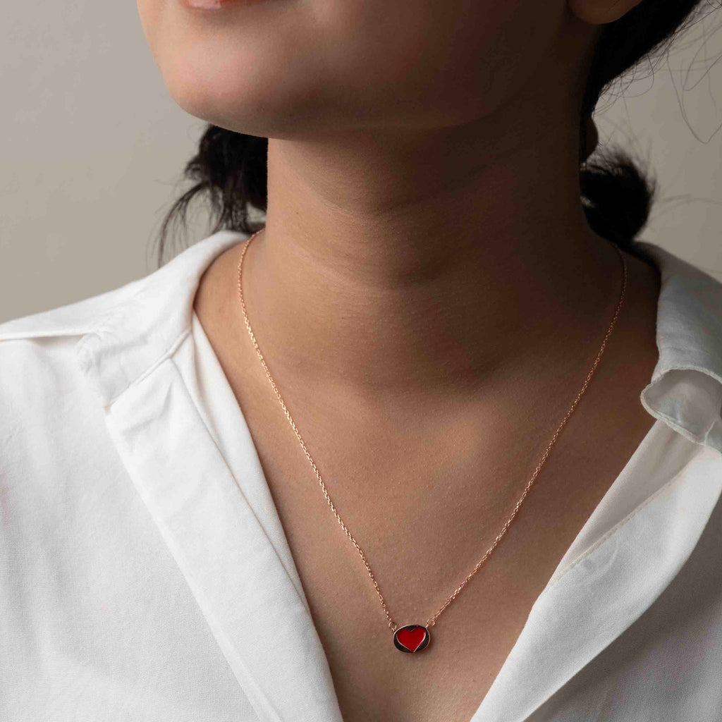 Delicate silver pendant necklace with a sparkling gemstone, set on a fine silver chain.