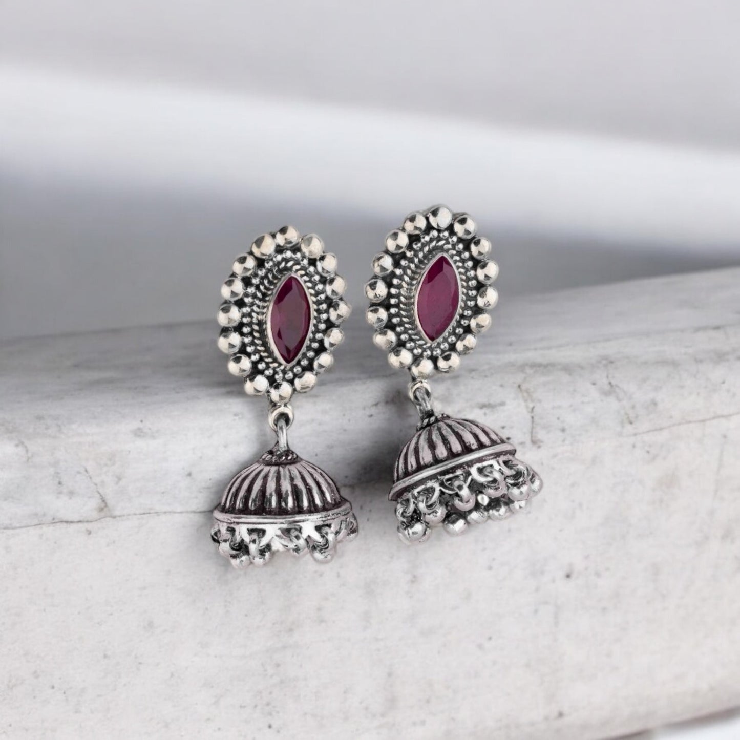 Intricately designed silver oxidized jhumka earrings with a traditional and vintage-inspired charm.