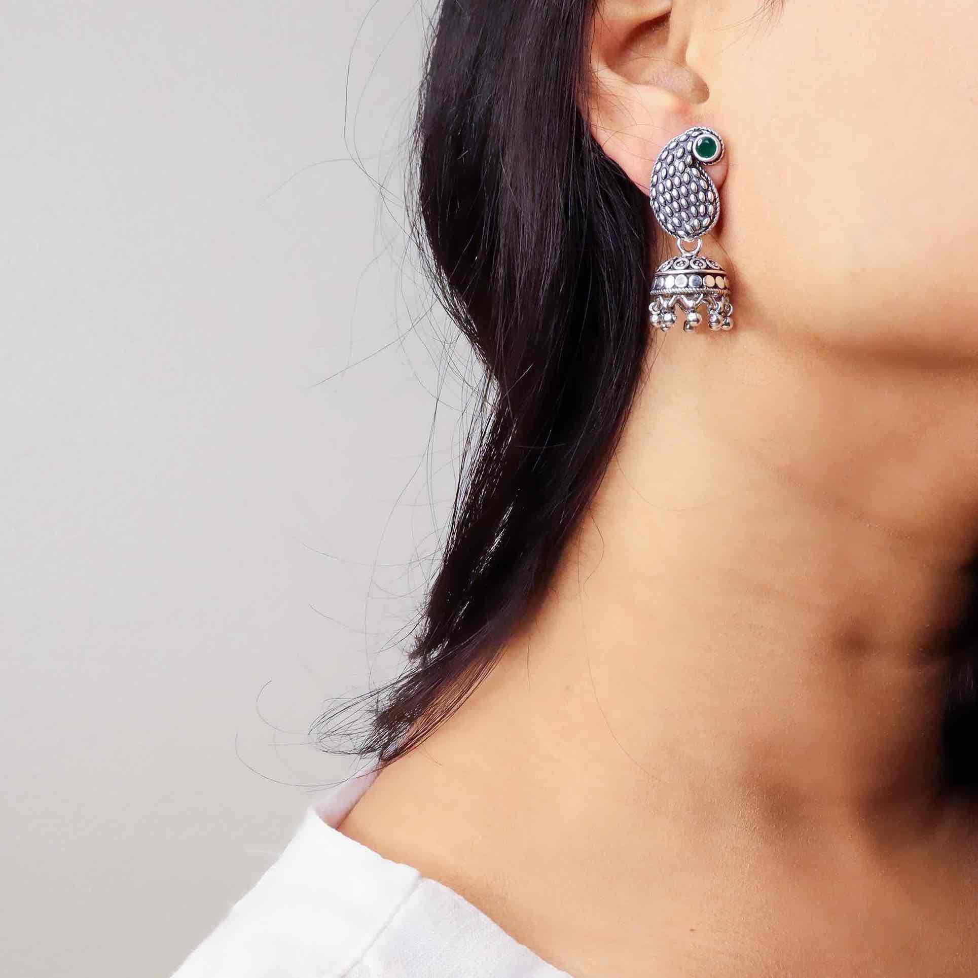 Intricately designed silver jhumka earrings showcasing traditional elegance and artisanal craftsmanship