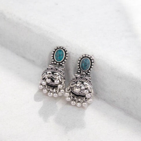 Intricately designed silver oxidized jhumka earrings with a traditional and vintage-inspired charm.