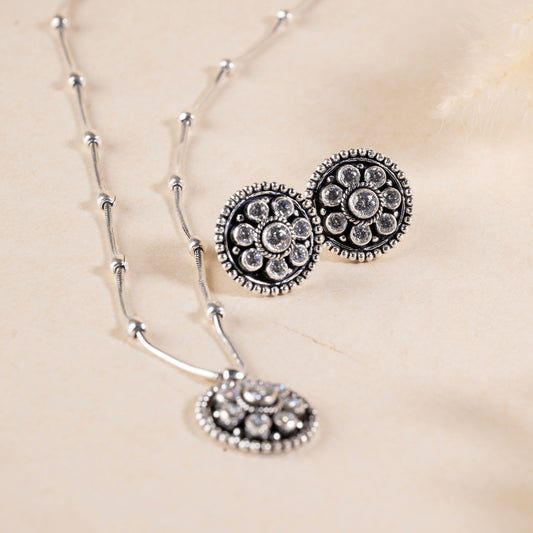 Delicate silver pendant necklace with a sparkling gemstone, set on a fine silver chain."