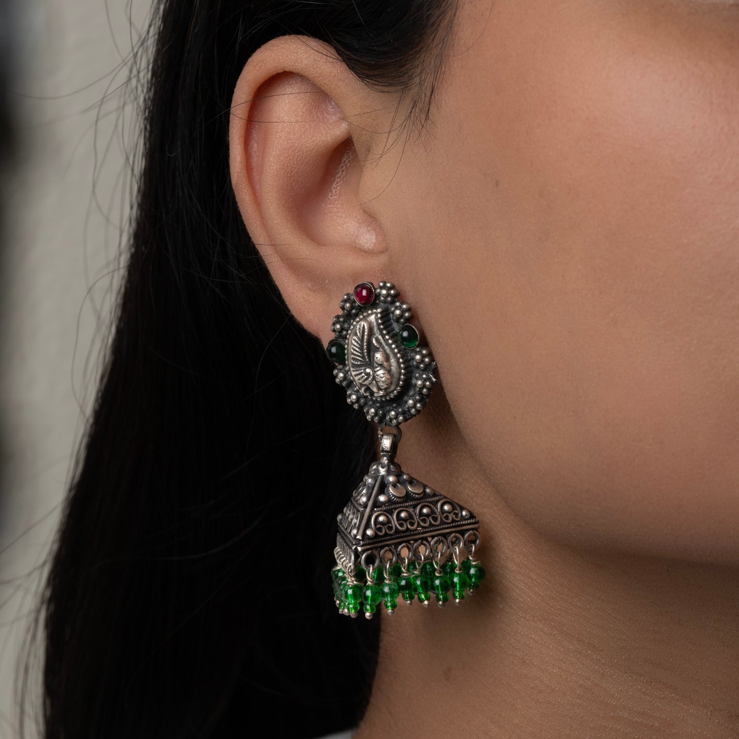 Intricately designed silver oxidized jhumka earrings with a traditional and vintage-inspired charm.