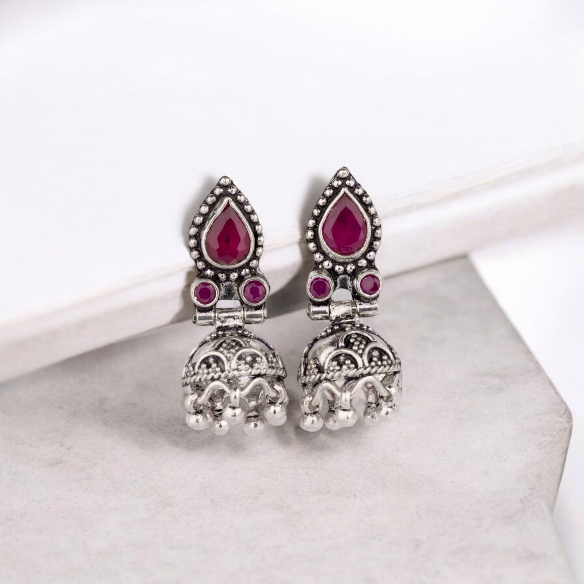 Intricately designed silver oxidized jhumka earrings with a traditional and vintage-inspired charm.