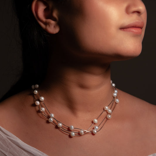 Minimalist silver choker with sleek, polished curves, ideal for casual and formal wear.