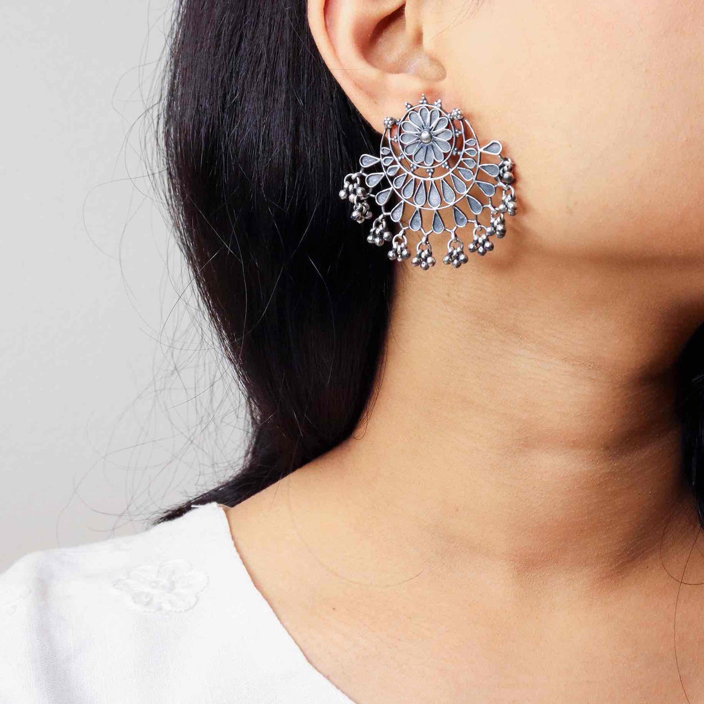 Stunning silver chandbali earrings with intricate detailing, embodying traditional elegance and grace. 