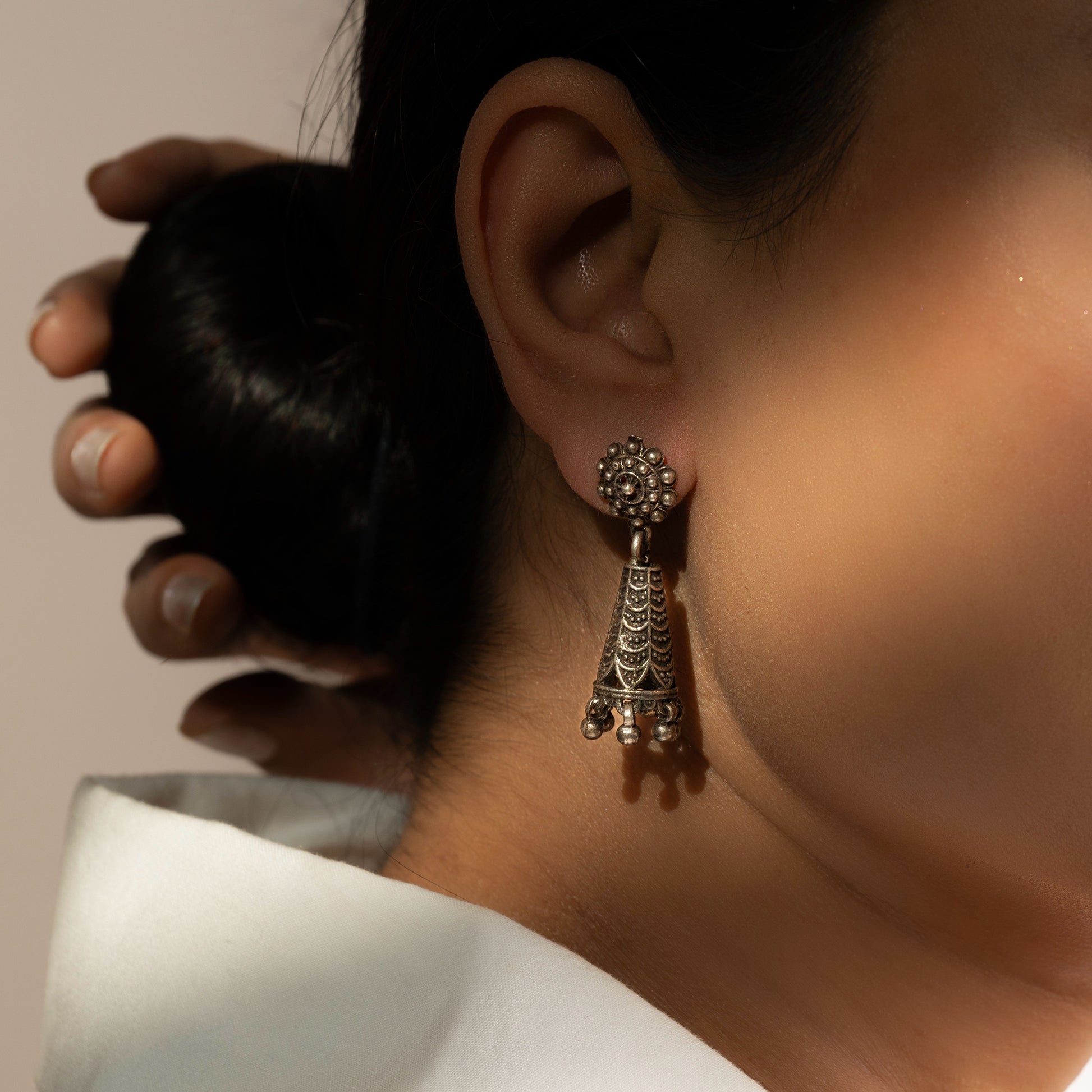 Intricately designed silver oxidized jhumka earrings with a traditional and vintage-inspired charm.