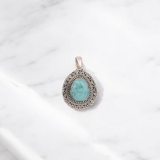 Elegant sterling silver pendant featuring a gemstone at the center, exuding timeless charm and grace