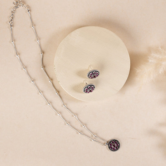 Delicate silver pendant necklace with a sparkling gemstone, set on a fine silver chain