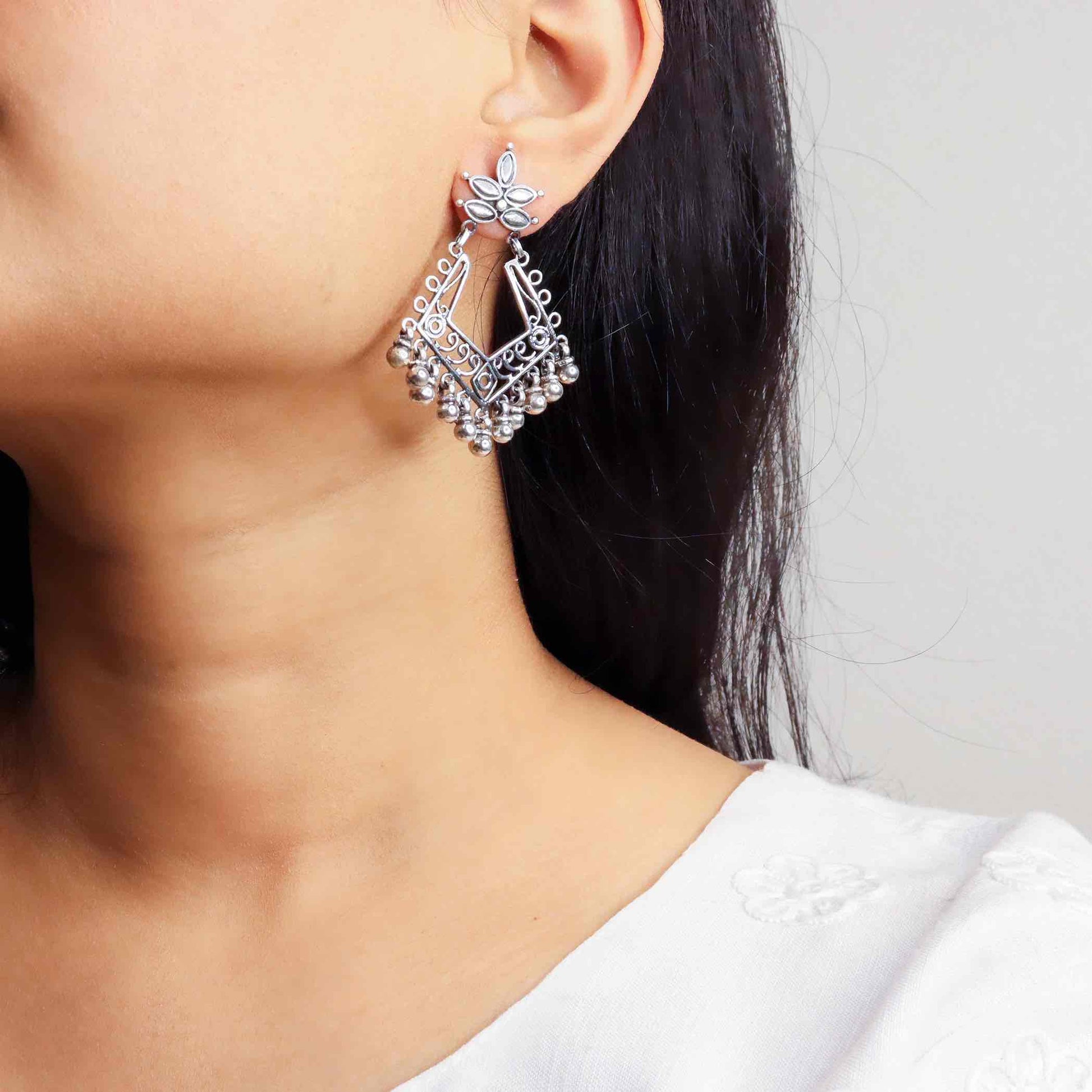 Stunning silver chandbali earrings with intricate detailing, embodying traditional elegance and grace. 