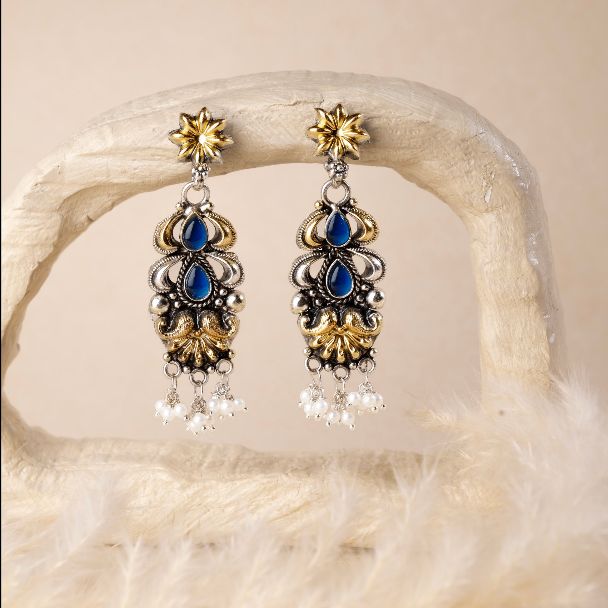 Stunning silver earrings with intricate detailing, embodying traditional elegance and grace. 