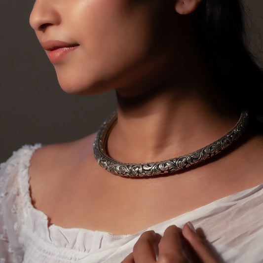 Beautiful oxidized silver choker with intricate patterns and a vintage finish, offering a bold, antique look for statement styling.
