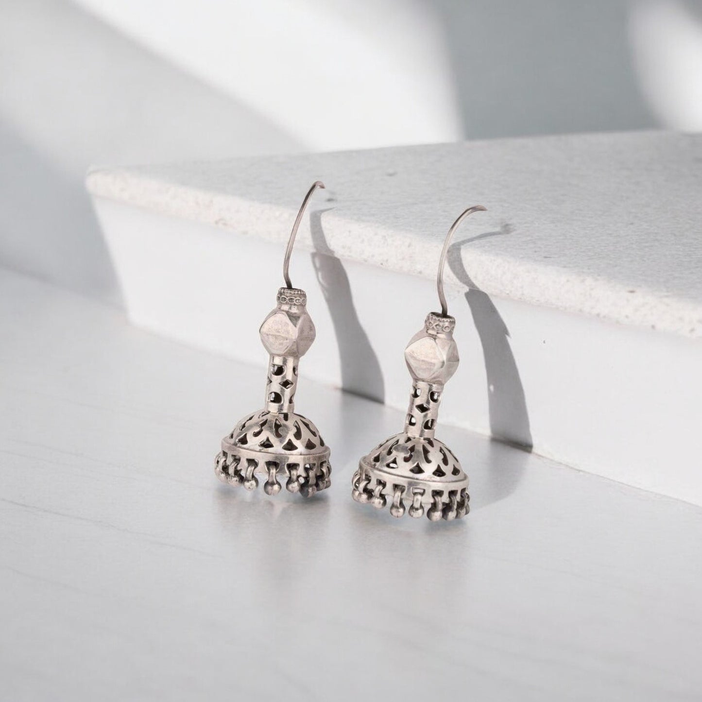 Intricately designed silver oxidized jhumka earrings with a traditional and vintage-inspired charm.