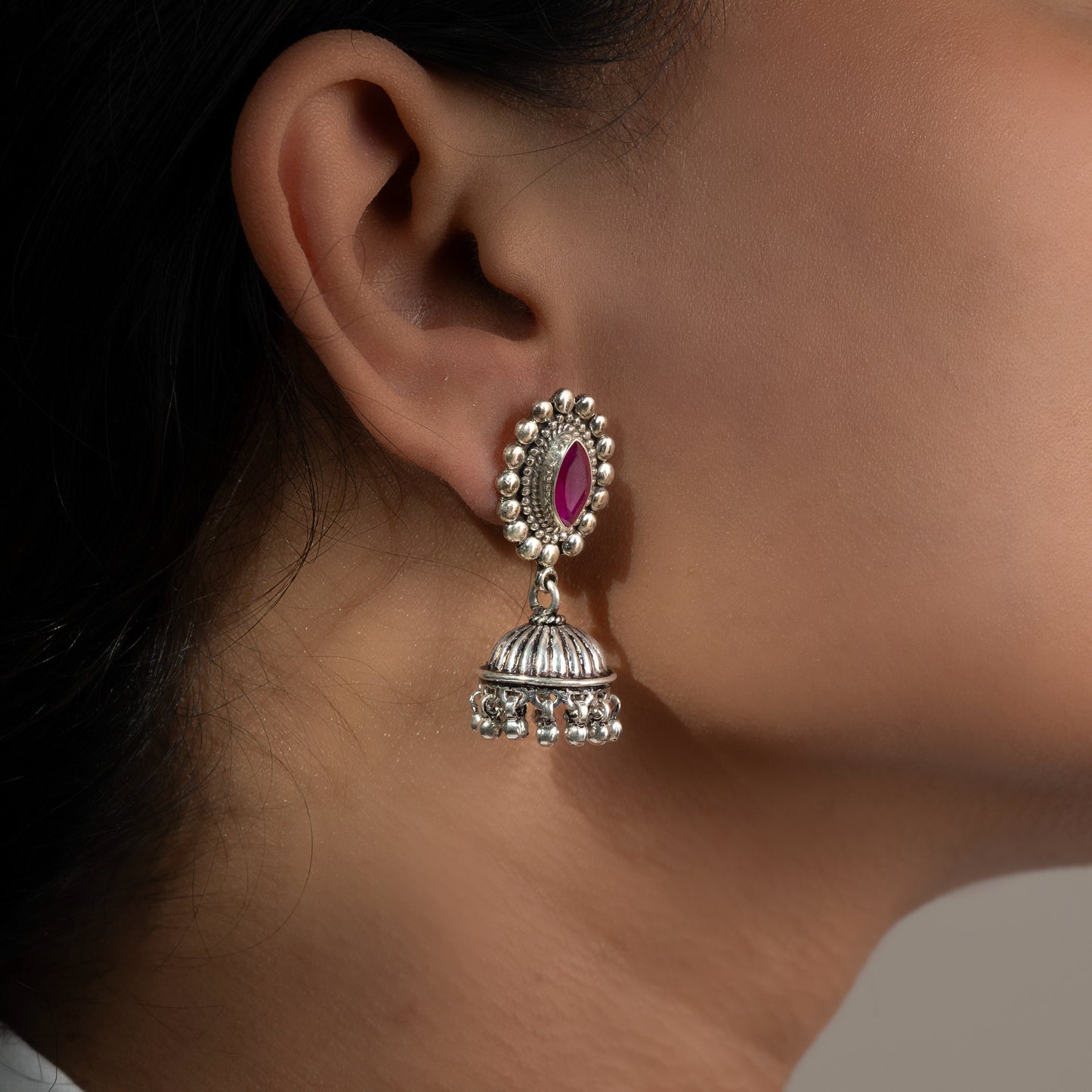 Intricately designed silver oxidized jhumka earrings with a traditional and vintage-inspired charm.