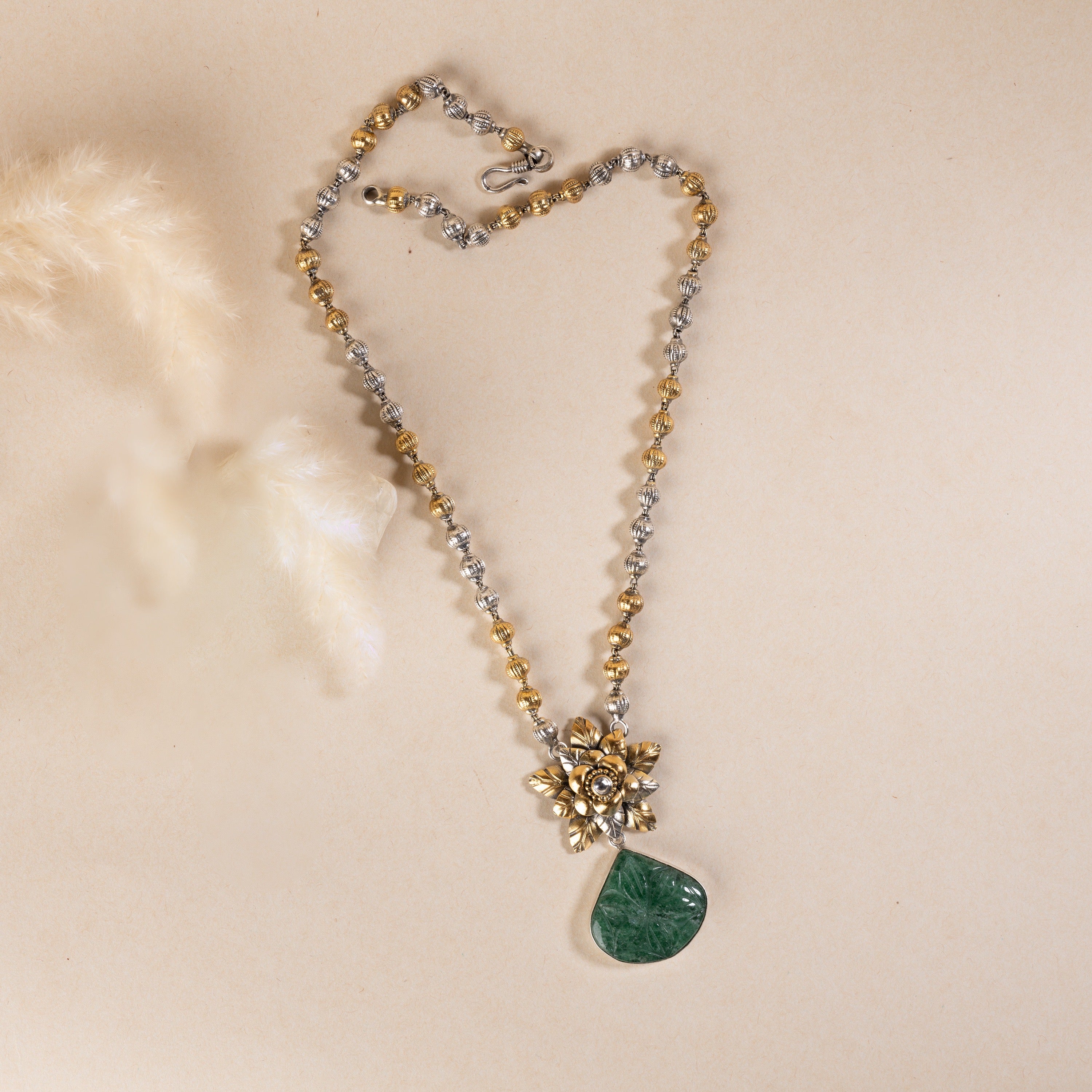Long sterling silver necklace with a big green colour stone at centre, adding a touch of sophistication to any outfit