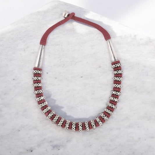 Handcrafted sterling silver long necklace featuring intricate detailing and a polished finish."