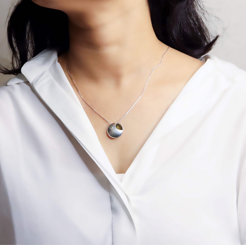 image of a delicate silver chain, showcasing its fine links and shiny, polished finish.