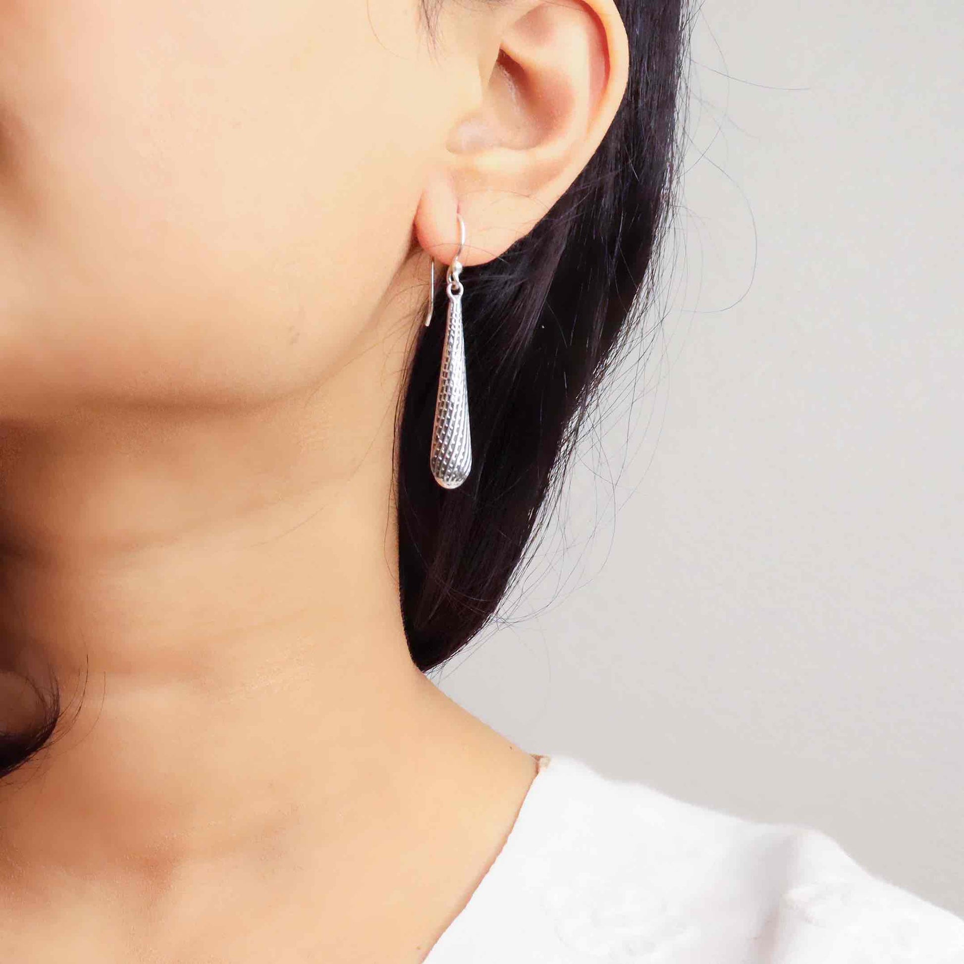 Elegant silver oxidized long earrings with intricate patterns and vintage-inspired charm