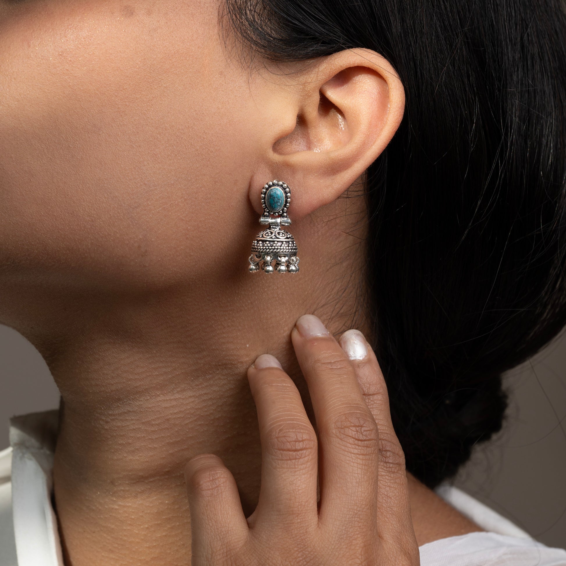 Intricately designed silver oxidized jhumka earrings with a traditional and vintage-inspired charm.