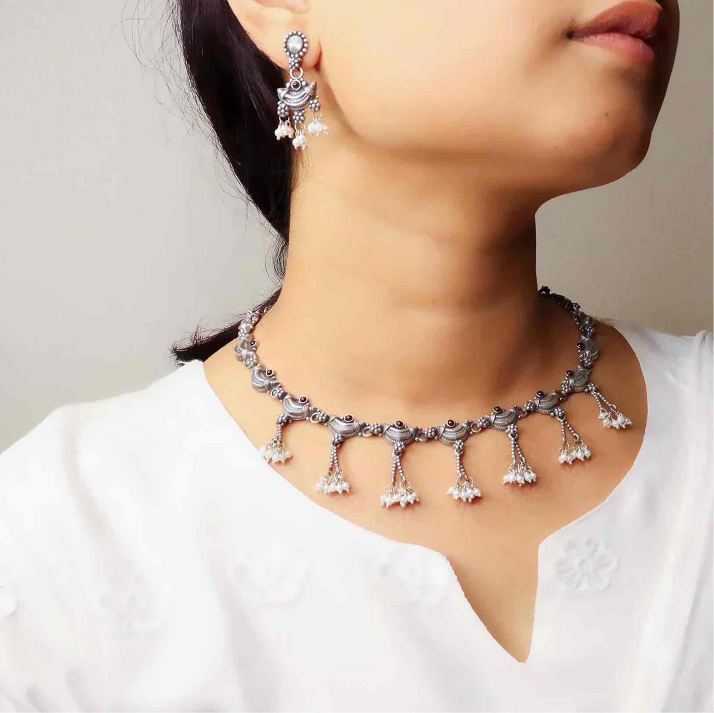 Beautiful oxidized silver necklace with intricate patterns and a vintage finish, offering a bold, antique look for statement styling.
