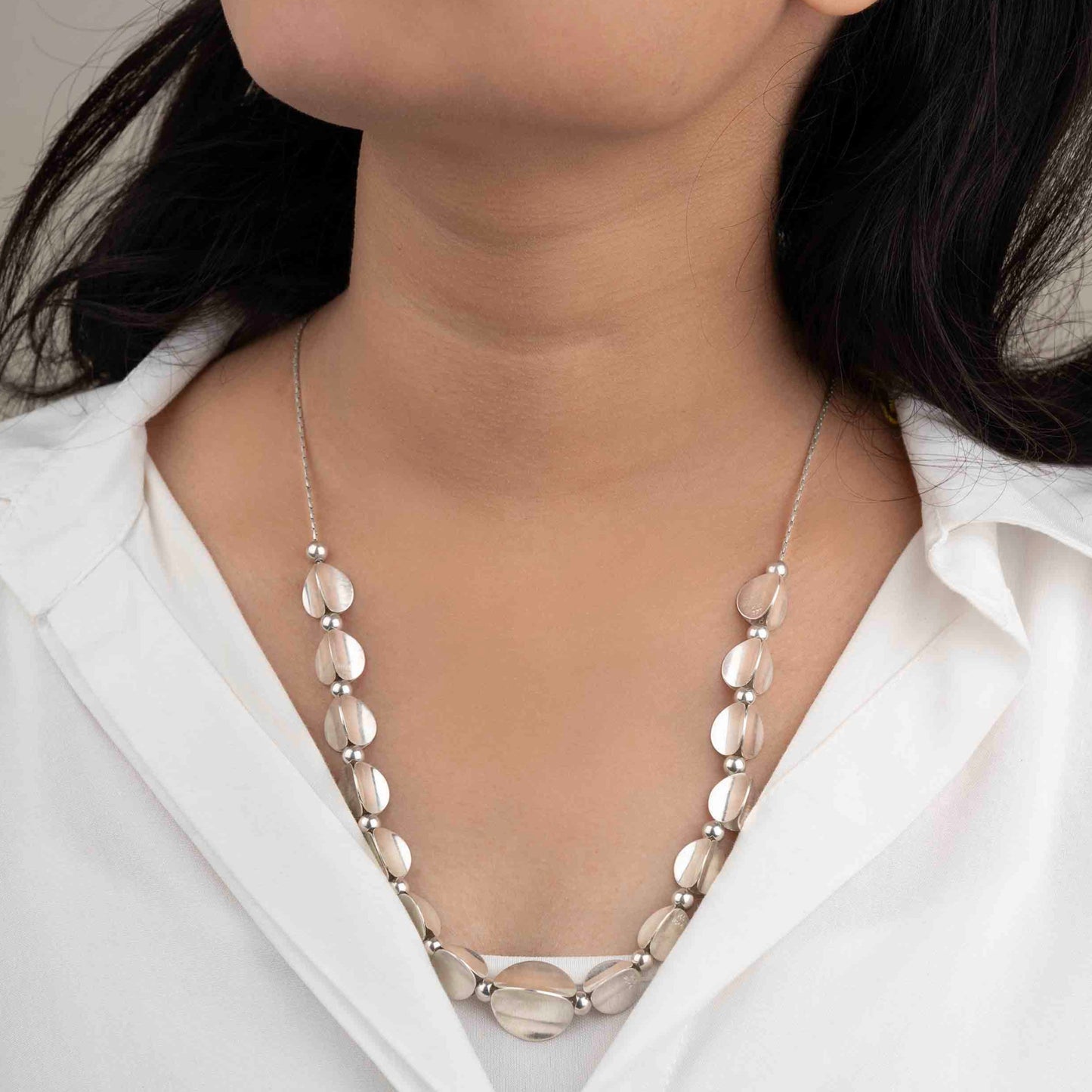 Stylish silver necklace with a sleek, polished finish and elegant design, perfect for adding a touch of sophistication to any outfit.