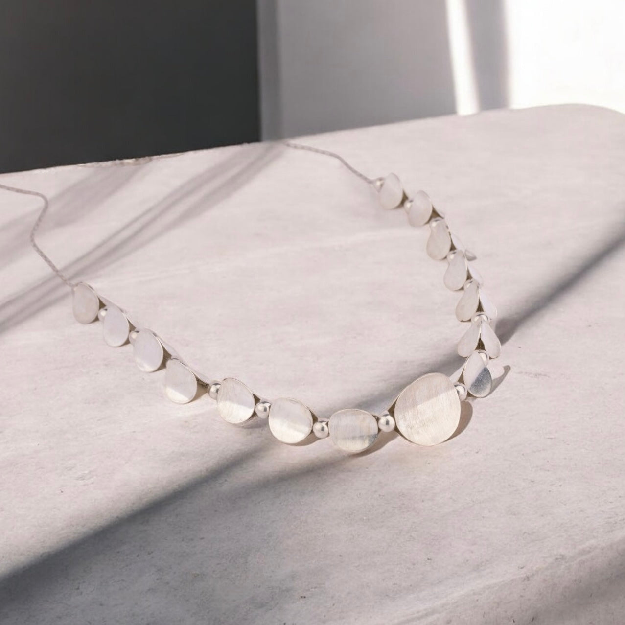 Stylish silver necklace with a sleek, polished finish and elegant design, perfect for adding a touch of sophistication to any outfit.