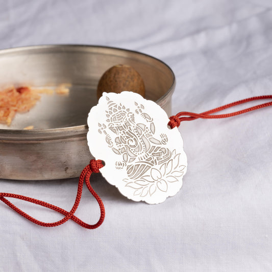 Elegant silver rakhi featuring a Ganapati motif"