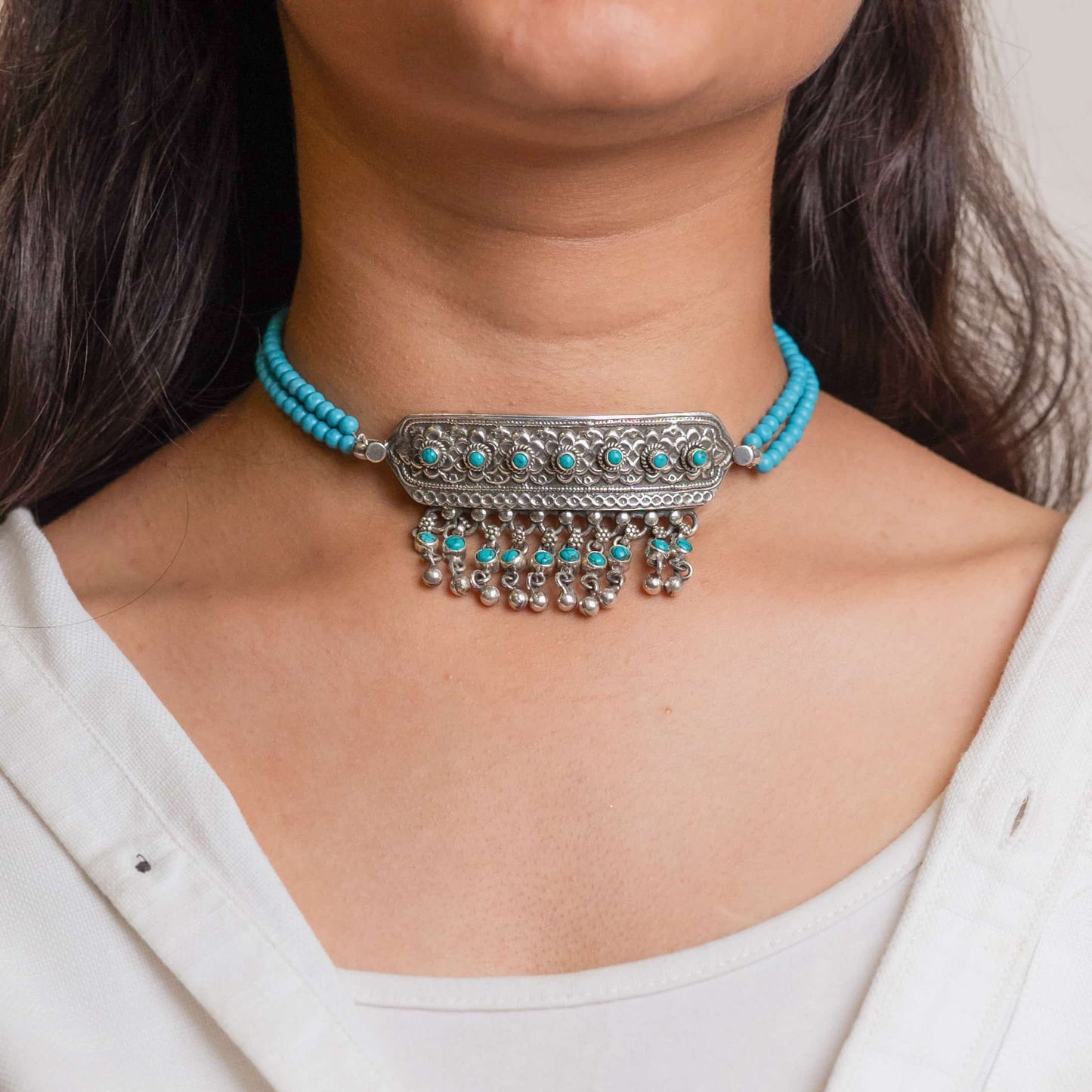 Beautiful silver choker with intricate patterns and a vintage finish, offering a bold, antique look for statement styling.
