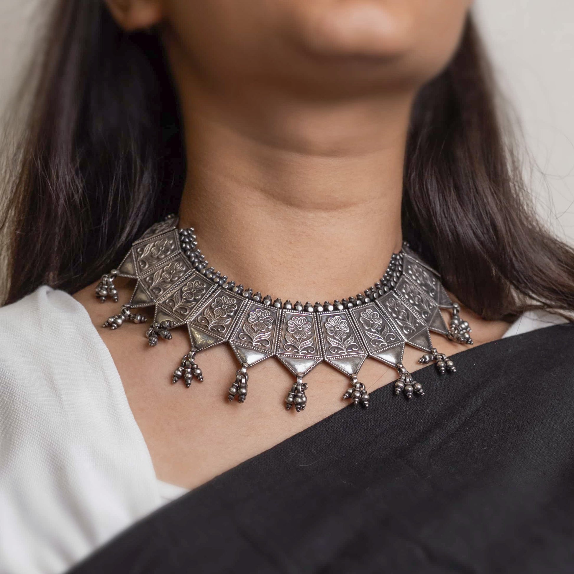 Striking oxidized silver necklace with detailed vintage-inspired patterns, offering a bold, unique look with a timeless, antique finish.