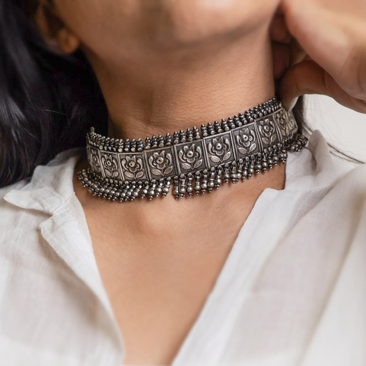 Beautiful silver choker with intricate patterns and a vintage finish, offering a bold, antique look for statement styling.
