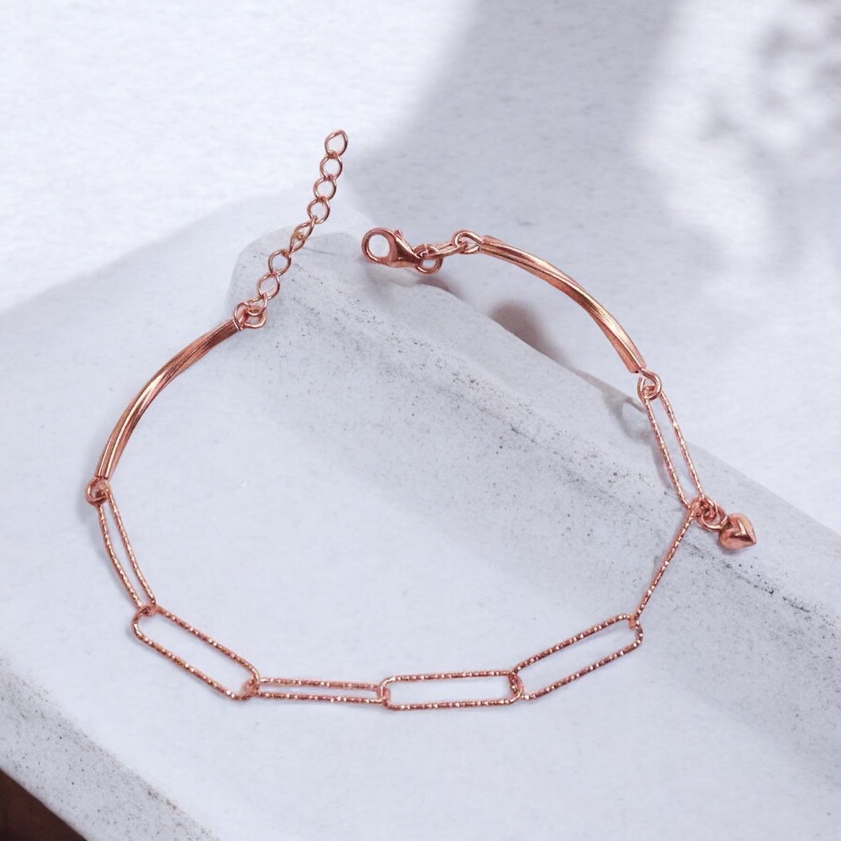 Elegant silver bracelet with a rose gold finish for women, featuring a sleek and sophisticated design, perfect for adding a touch of warmth and luxury to any outfit.
