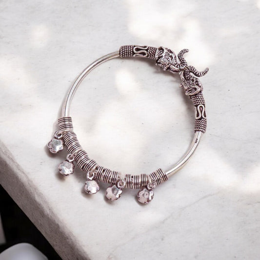 Elegant silver hand cuff or bracelet for women, featuring a sleek and sophisticated design, perfect for adding a touch of refinement to any outfit.

