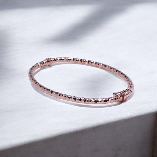 Elegant silver bracelet with a rose gold finish for women, featuring a sleek and sophisticated design, perfect for adding a touch of warmth and luxury to any outfit.

