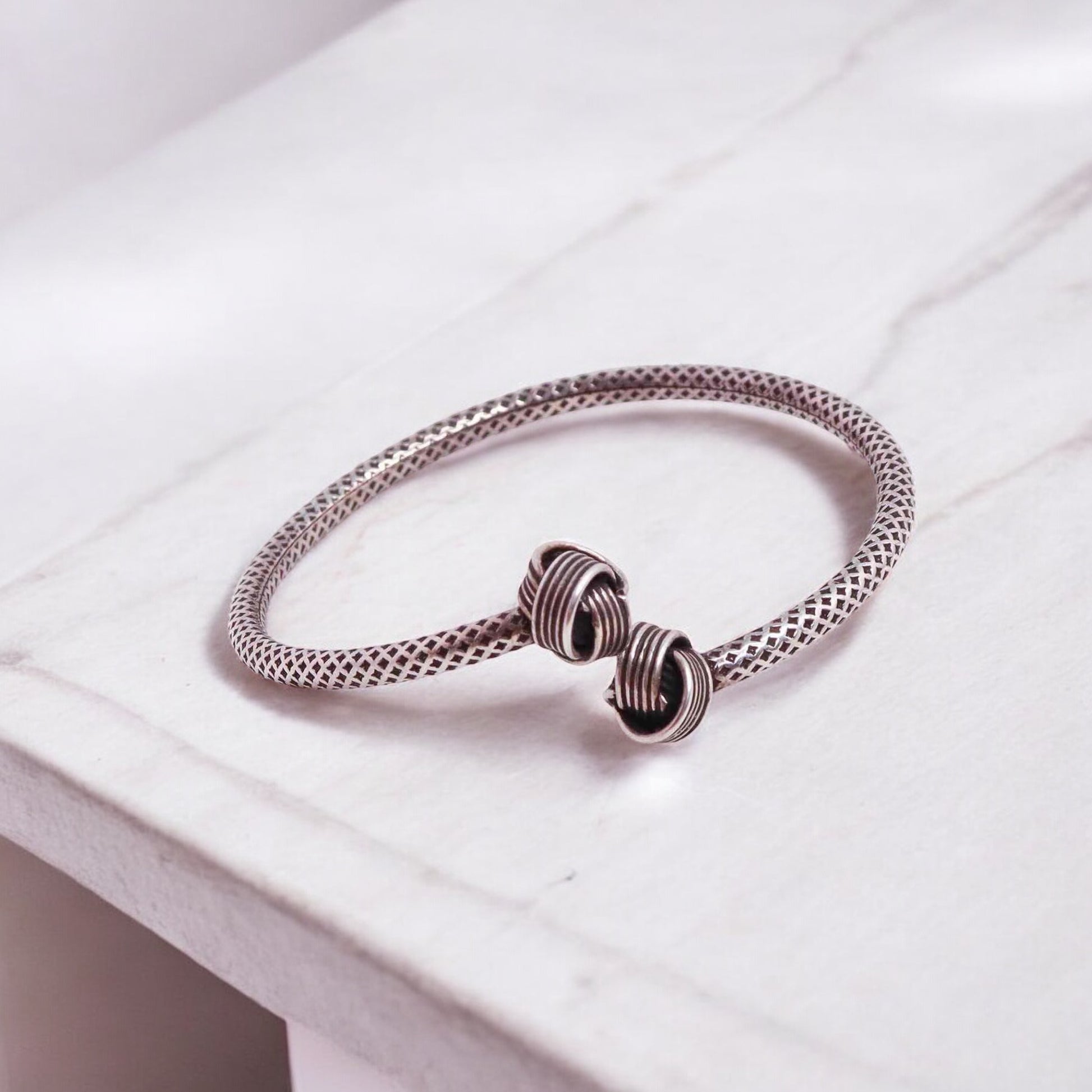 Elegant silver hand cuff or bracelet for women, featuring a sleek and sophisticated design, perfect for adding a touch of refinement to any outfit.

